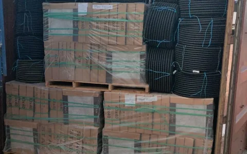 Palletised tiles and electrical conduits loaded for Douala